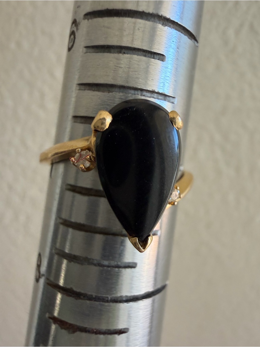 14k yellow gold with black onyx pear shaped stone & 2 diamond accents